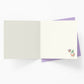 Open card with a small illustration of a flower on a white background