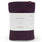 Purple face cloth with a white label on a white background